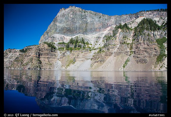 Llao Rock reflected in rippled water. Crater Lake National Park, Oregon, USA.