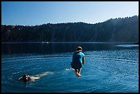 Girl jumps in water in Governors Bay, Wizard Island. Crater Lake National Park ( color)