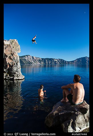 Man jumping from cliff as others look, Cleetwood Cove. Crater Lake National Park (color)