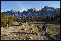 Backpackers walking on trail in meadow towards mountains. Kings Canyon National Park ( color)