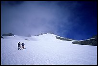 Mountaineers climbing a snow field on Sahale Peak,  North Cascades National Park. Washington, USA. (color)