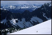 Mountain ridges, and mountaineers on snow field, North Cascades National Park. Washington, USA. (color)