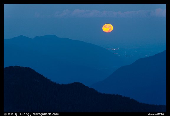 Moon setting over ridges, North Cascades National Park. Washington, USA.