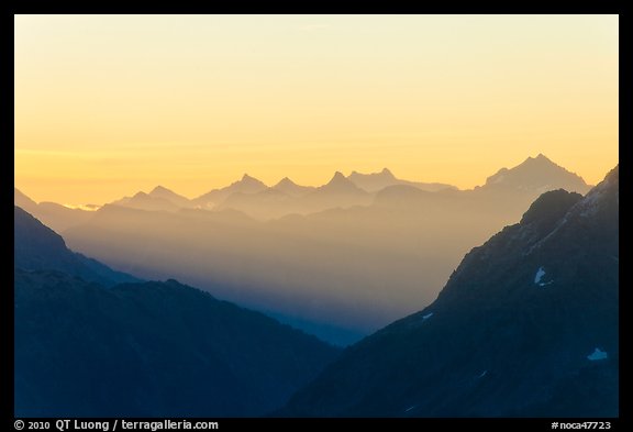 First sunrays lighting peaks above Cascade Pass, North Cascades National Park. Washington, USA.
