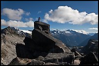 Man sitting on rock photographs mountain panorama, North Cascades National Park.  ( color)