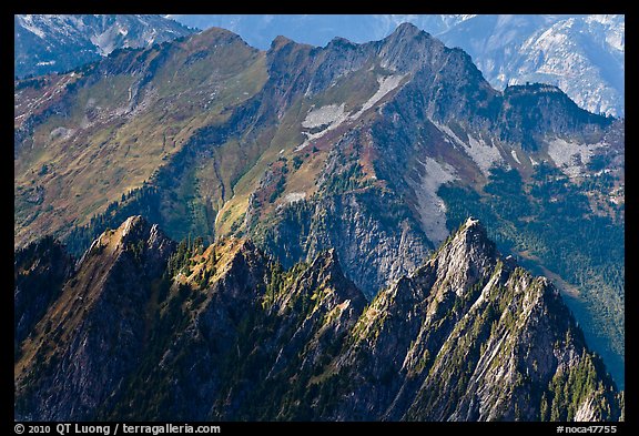Steep forested spires in dabbled light, North Cascades National Park.  (color)