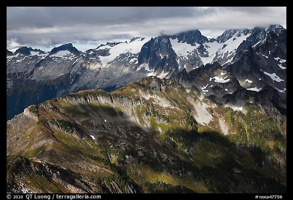 Cloud-capped mountains in dabbled light, North Cascades National Park. Washington, USA.