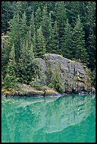 Trees and boulders reflected in Gorge Lake, North Cascades National Park Service Complex.  ( color)