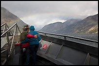 Couple at bow of boat looking at rainbow over Lake Chelan, North Cascades National Park Service Complex.  ( color)