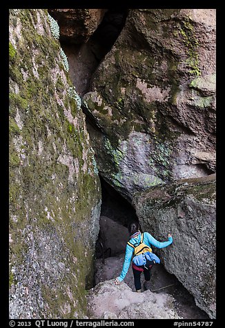 Woman walking into Balconies Cave. Pinnacles National Park, California, USA.