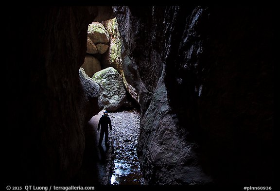 Hiker with lamp in Bear Gulch Cave. Pinnacles National Park (color)