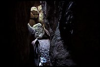Hiker with lamp in Bear Gulch Cave. Pinnacles National Park ( color)