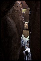 Hiker in narrow and deep section of Lower Bear Gulch Cave. Pinnacles National Park ( color)
