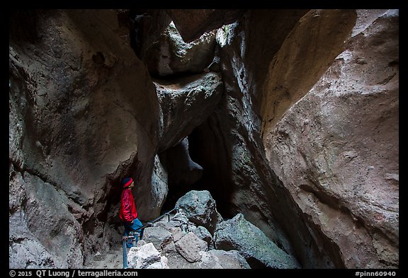 Hiker looking from staircase down into Lower Bear Gulch Cave. Pinnacles National Park, California, USA.