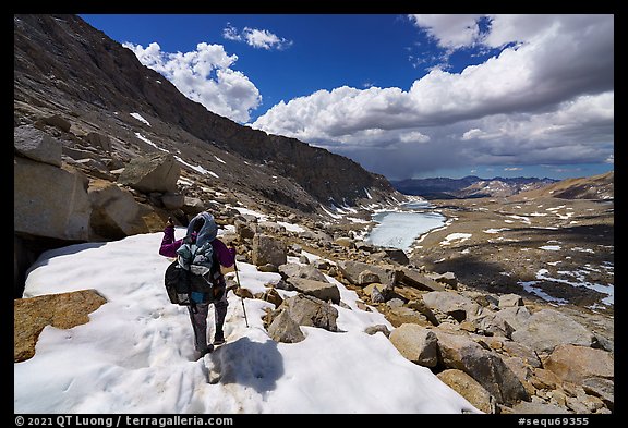Backpacker crossing snowy section of the John Muir Trail below Forester Pass, Sequoia National Park. California (color)