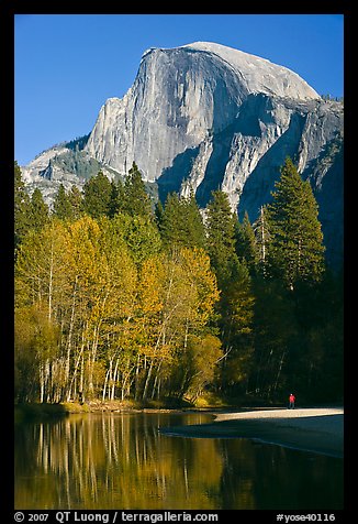 Banks of  Merced River with hiker below Half-Dome. Yosemite National Park, California, USA.