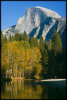 Banks of  Merced River with hiker below Half-Dome. Yosemite National Park, California, USA.
