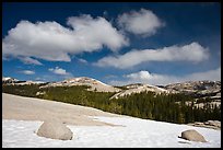 Snow on slab, boulders, and distant domes, Tuolumne Meadows. Yosemite National Park, California, USA.