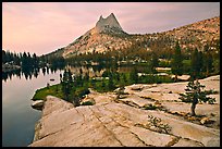 Granite slab, Upper Cathedral Lake, and Cathedral Peak, sunset. Yosemite National Park, California, USA.
