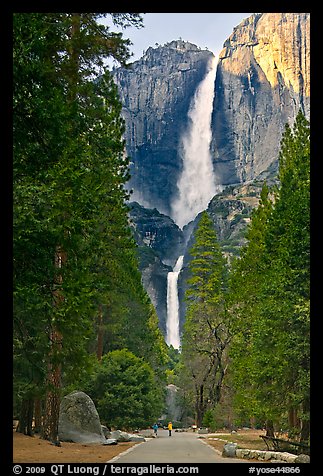 Tourists on path dwarfed by Upper and Lower Yosemite Falls. Yosemite National Park (color)