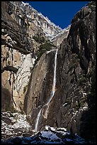 Lower Yosemite Falls and rock wall with snowy trees on rim. Yosemite National Park ( color)