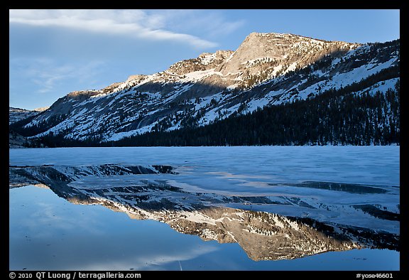 Tenaya Peak reflected in partly iced Tenaya Lake. Yosemite National Park, California, USA.