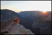 Hiker looking over the edge of the Diving Board, sunset. Yosemite National Park ( color)