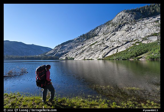 Park visitor with backpack looking, Merced Lake, morning. Yosemite National Park, California, USA.