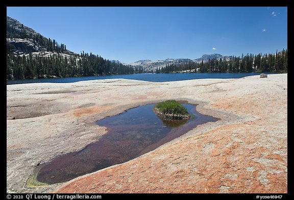 Colorful slab, pothole, and lower Cathedral Lake. Yosemite National Park, California, USA.
