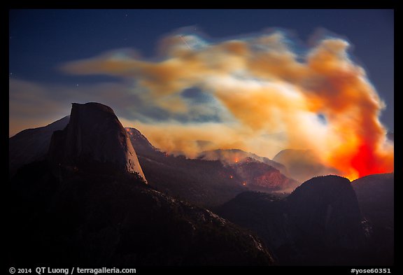 Half-Dome, fire and smoke at night. Yosemite National Park, California, USA.