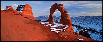 Desert Arch and mountains at sunset. Arches National Park (Panoramic color)