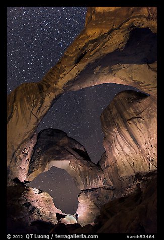 Visitor lighting up Double Arch at night. Arches National Park, Utah, USA.