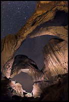 Visitor lighting up Double Arch at night. Arches National Park, Utah, USA.