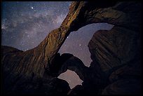 Double Arch at night with Milky Way. Arches National Park, Utah, USA.