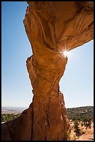Sunburst at the crack of Broken Arch. Arches National Park, Utah, USA. (color)