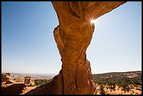 Broken Arch seen from below with sunburst at the crack. Arches National Park, Utah, USA. (color)