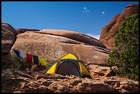 Tent with prayer flags amongst sandstone rocks. Arches National Park ( color)