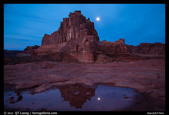 Courthouse tower and moon reflected in pothole. Arches National Park (color)