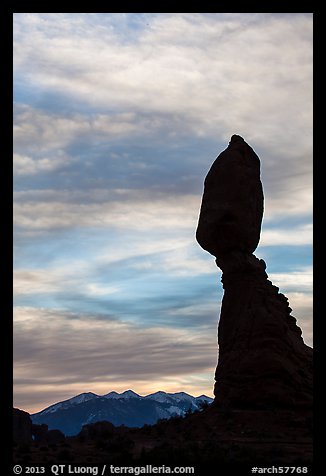 Balanced Rock silhouetted against La Sal Mountains and sky. Arches National Park, Utah, USA.