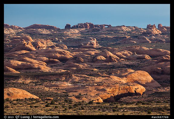 Sandstone domes with arch in background. Arches National Park, Utah, USA.