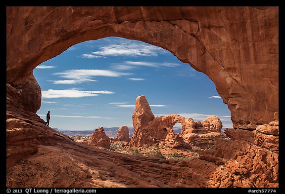 Park visitor looking, Turret Arch framed by North Window. Arches National Park, Utah, USA.