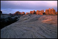 Sandstone swirls and Needles near Elephant Hill, sunset. Canyonlands National Park, Utah, USA.