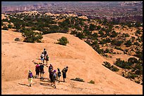 Hikers on Whale Rock. Canyonlands National Park, Utah, USA. (color)