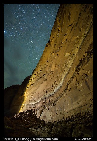 Illuminated canyon wall with rock art under starry sky, Horseshoe Canyon. Canyonlands National Park, Utah, USA.
