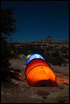Lit tents at night in the Dollhouse. Canyonlands National Park, Utah, USA.