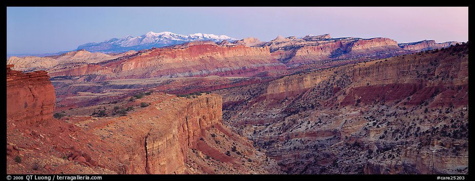 Panorama of multi-hued cliffs and Henry Mountains at dusk. Capitol Reef National Park, Utah, USA.