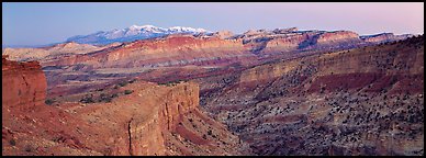 Panorama of multi-hued cliffs and Henry Mountains at dusk. Capitol Reef National Park (Panoramic color)