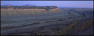 Long chain of cliffs of the Waterpocket Fold at dusk. Capitol Reef National Park (Panoramic color)