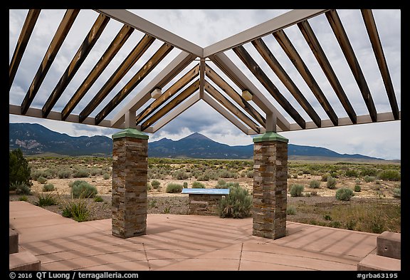 Courtyard, sign and mountains, Great Basin Visitor Center. Great Basin National Park (color)