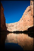 Steep limestone canyon walls reflected in Colorado River, early morning. Grand Canyon National Park ( color)